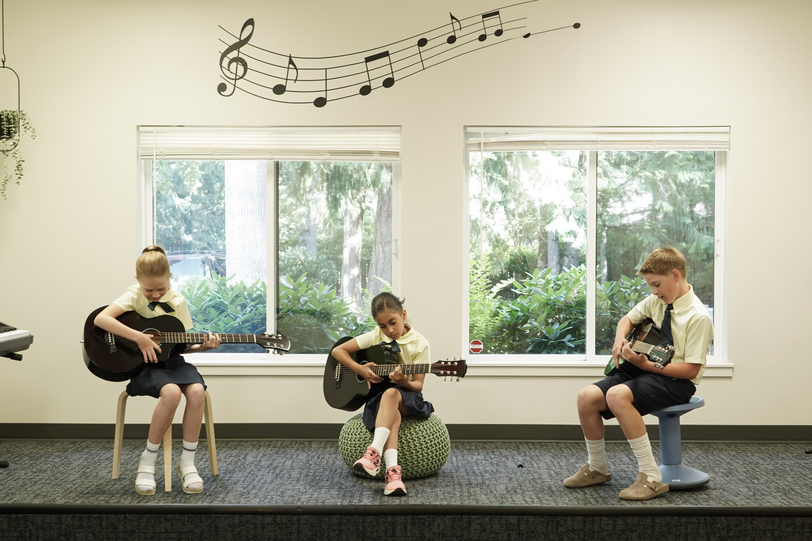 Students performing on stage with guitars